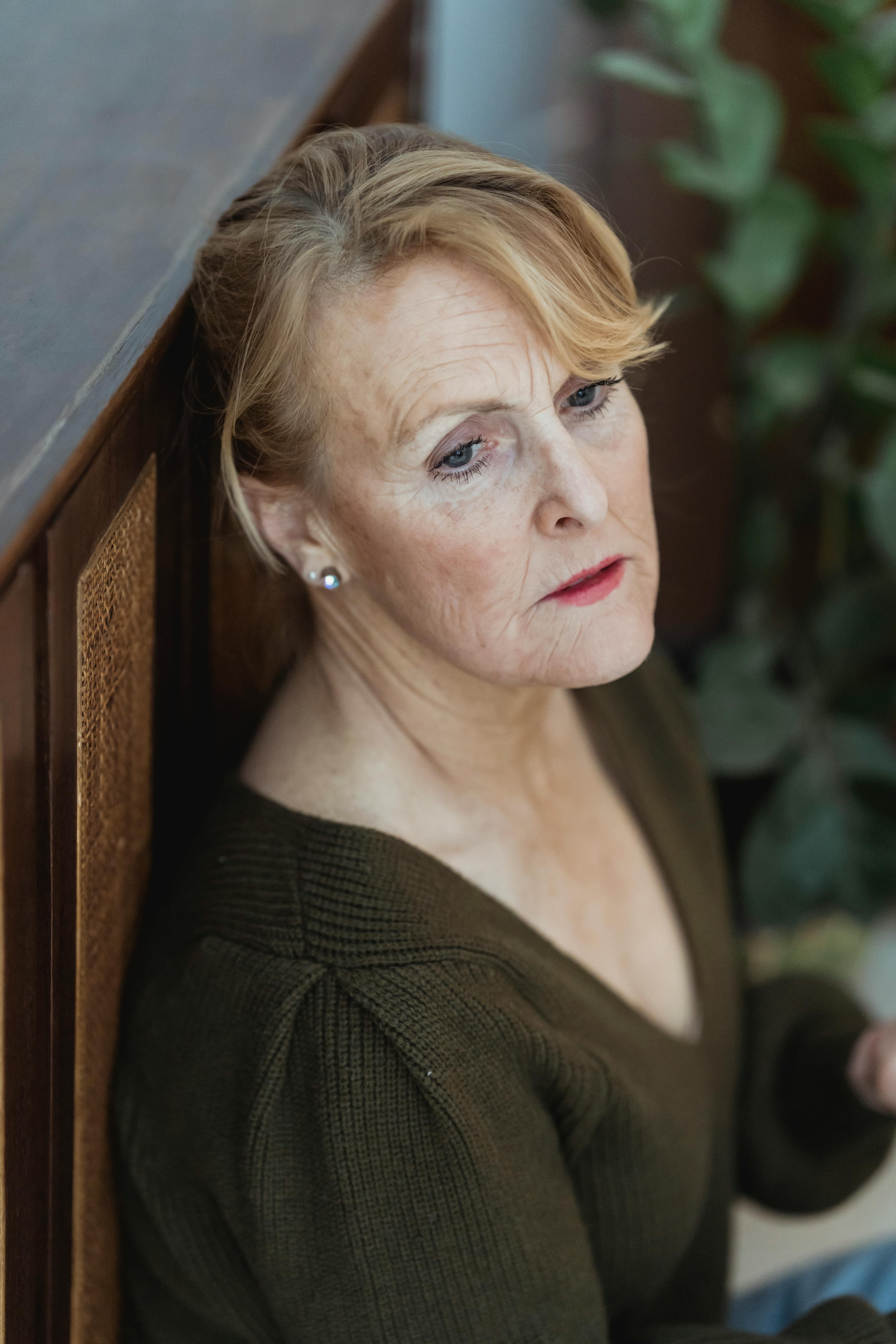 A woman in quiet reflection outdoors
